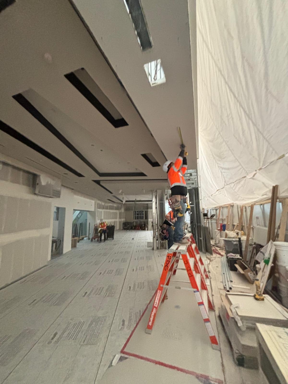 Interior ceiling with smooth finished surfaces and dark architectural reveals